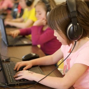 Student on ipad wearing headphones