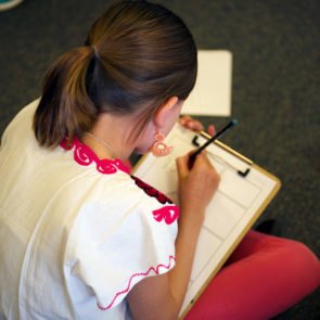 Student working on a clipboard